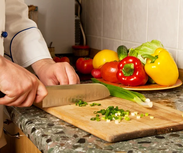 Cook chopped onion on a wooden board — Stock Photo, Image