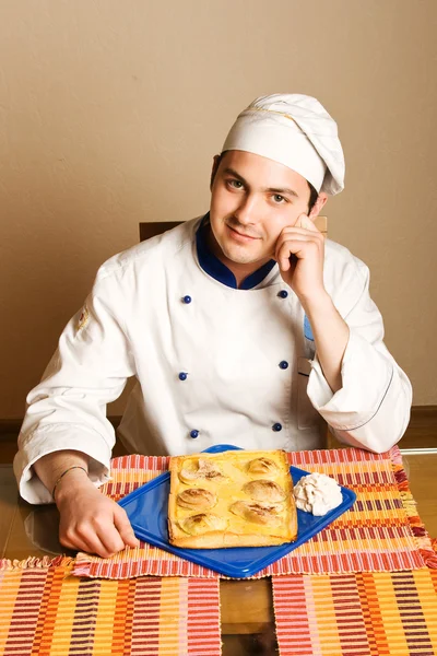 Handsome young chef in the living room w — Stock Photo, Image