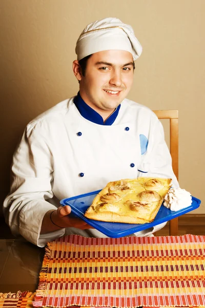 Handsome young chef in the living room w — Stock Photo, Image