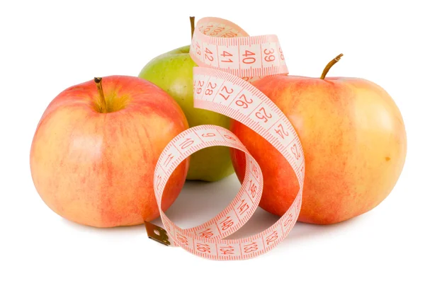 Pink ölçüm bandı ve üç elma — Stok fotoğraf