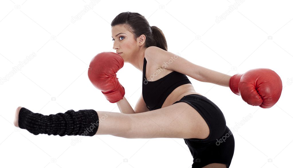 Kickboxing girl giving strong kick