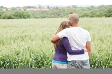 Rear view of couple with arms clipart