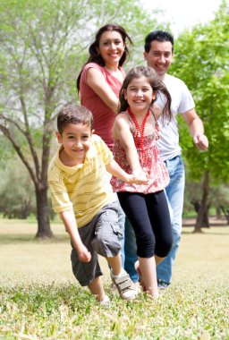 Happy family having fun in the park clipart