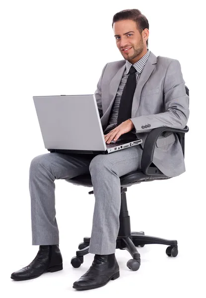 Hombre de negocios sentado con portátil Fotos de stock