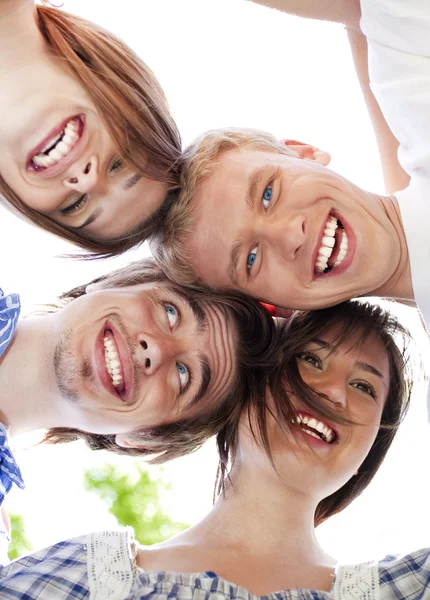 Cirkel av glada vänner huvuden ihop — Stockfoto