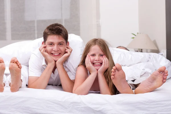 Aimer frère et sœur couché et s'amuser sur le lit — Photo