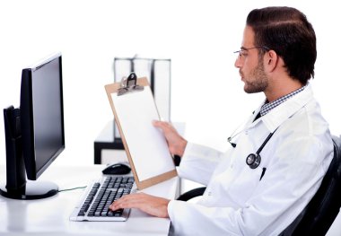 Young ethnic doctor looking at medical report deeply clipart