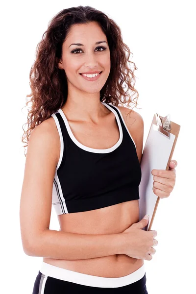 Mujer de fitness sosteniendo un tablero de clip en blanco — Foto de Stock