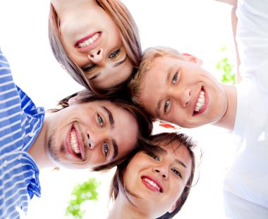 Smiling young couples with clear sky in the background clipart