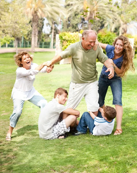 Family holding back grandfather — Stock Photo, Image