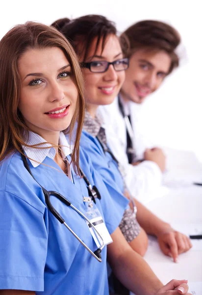Doctors in hospital gowns in row — Stock Photo, Image