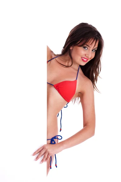 Bikini babe fönstertittare bakom styrelsens tecken — Stockfoto