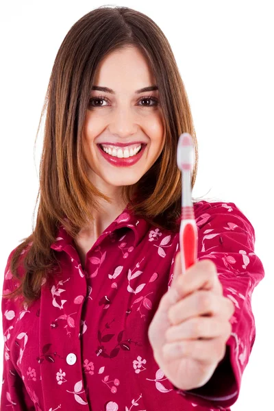 Junge Frau zeigt Zahnbürste — Stockfoto