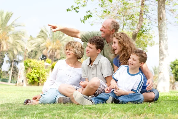 Potrait of grandfather pointing with family — Stock Photo, Image