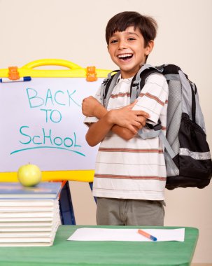 Happy student in his classroom clipart