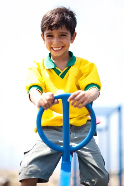 Young kid enjoying swing ride — Stock Photo, Image