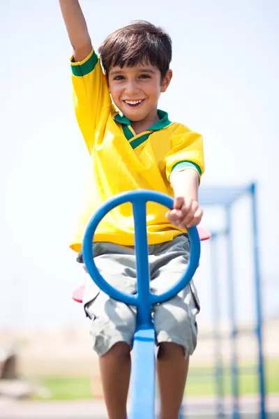 Young kid enjoying swing ride — Stock Photo, Image