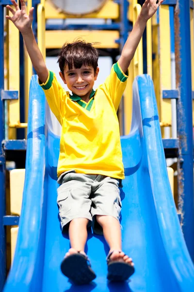 Young smart kid sliding down the swing — Stock Photo, Image