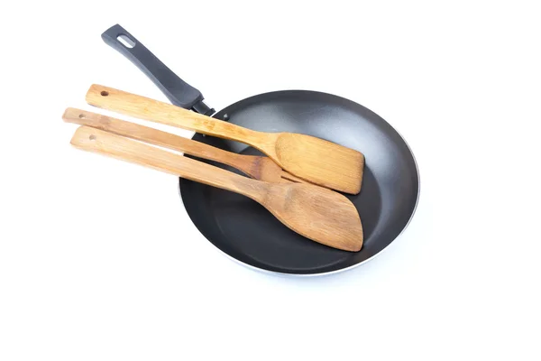 Wooden kitchen shovel in a frying pan — Stock Photo, Image