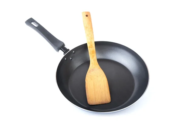 Wooden kitchen shovel in a frying pan — Zdjęcie stockowe