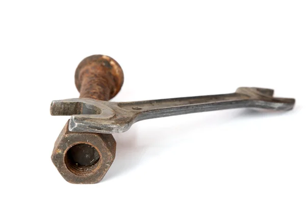 Wrench and rusty bolt with nut — Stock Photo, Image