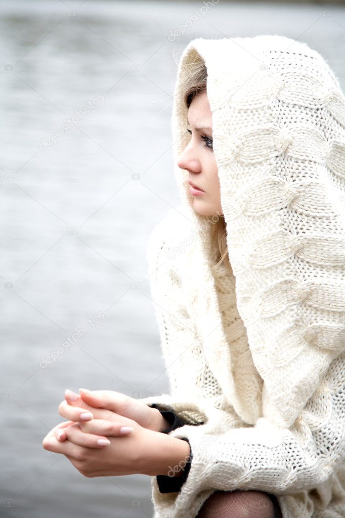 The thoughtful girl in knitted dress