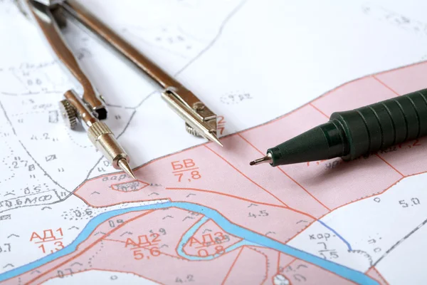 Topographic map of district with measuring instrument — Stock Photo, Image