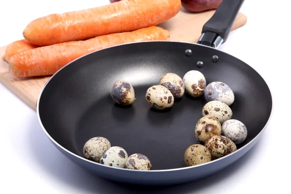 Carrots on a chopping board and quail eggs — Stock Photo, Image