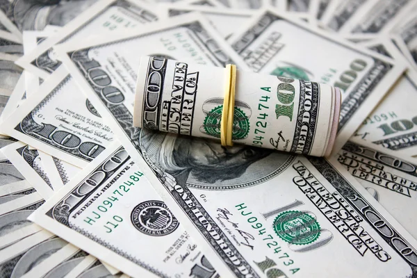 Rolled money cutout on a background dollars — Stock Photo, Image