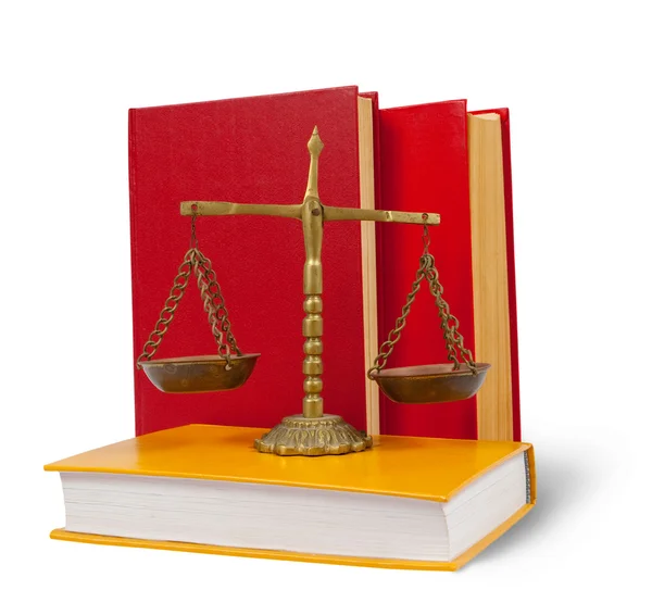 Scales of justice atop legal books — Stock Photo, Image