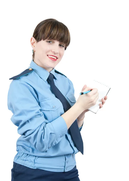 Mulher de uniforme escrevendo em seu bloco de notas — Fotografia de Stock