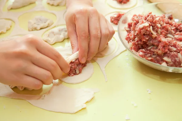 Rolling of meat stuffing into dough — Stock Photo, Image
