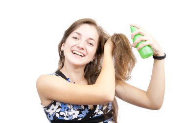 Beauty girl spraying hair over white clipart