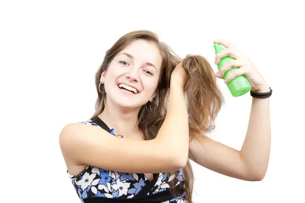 Beauty girl spraying hair over white — Stockfoto