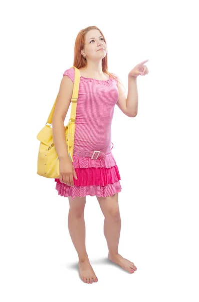 Дівчина з жовтою сумкою, що вказує геть — стокове фото