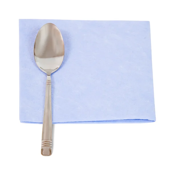 Spoon on blue napkin — Stock Photo, Image