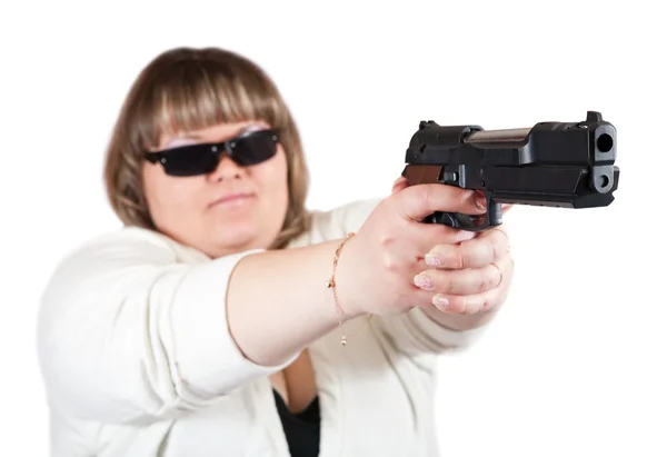 Big girl aiming a black gun — Stock Photo, Image