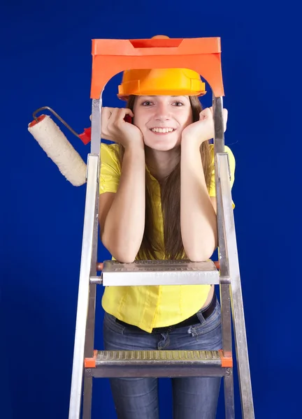 Girl with paint rollers on stepladder — Stock Photo, Image