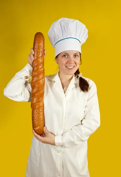 Baker holding long bread rolls — Stock Photo, Image