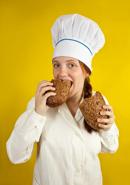 Woman is eating bread — Stock Photo, Image
