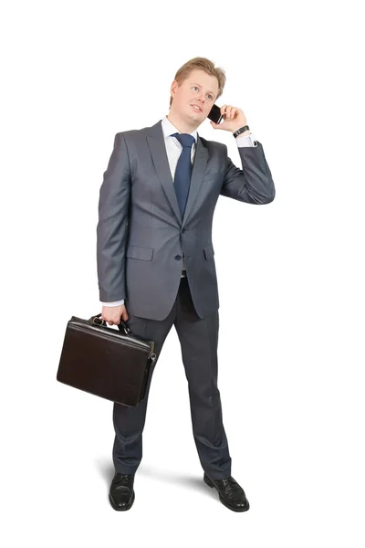 Бизнесмен говорит по мобильному через белый — стоковое фото