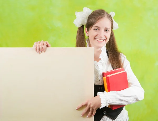 Schoolmeisje bezit leeg doek — Stockfoto