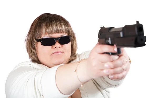 Big girl aiming a black gun — Stock Photo, Image