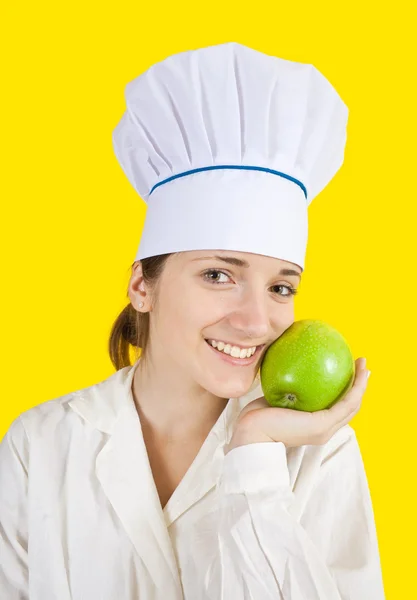 Kadın aşçı holding elma — Stok fotoğraf