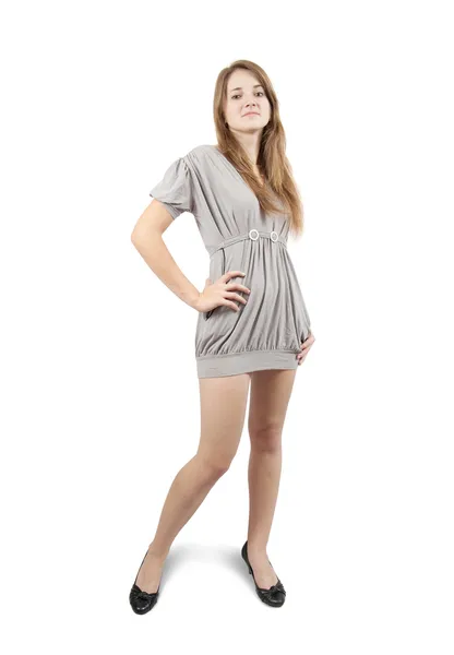 Стоячая девушка в сером сексуальном платье. Изолированные на белом — стоковое фото