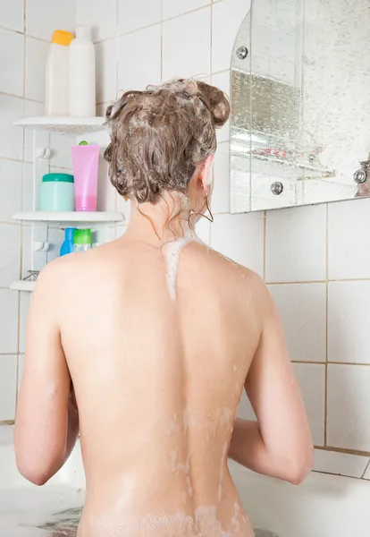 Meisje shampooes in badkamer — Stockfoto