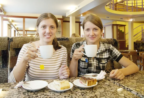 Dívky s šálkem čaje v kavárně — Stock fotografie