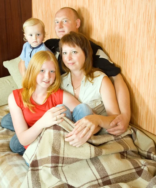 Family relaxing together on sofa — Stock Photo, Image