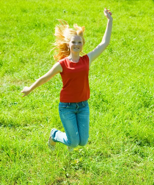 Jumping red-haired teen girl — Stock Photo, Image