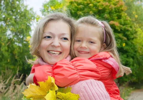 Woman with daughter in autumn — Stock Photo, Image